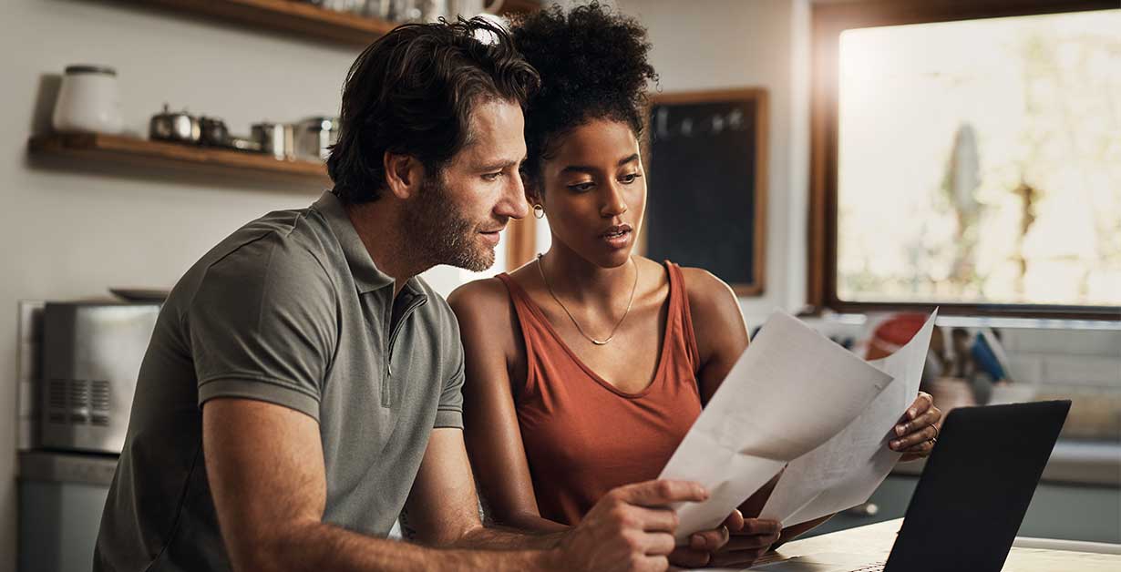 a couple reviewing their personal finances and their debt to income ratio